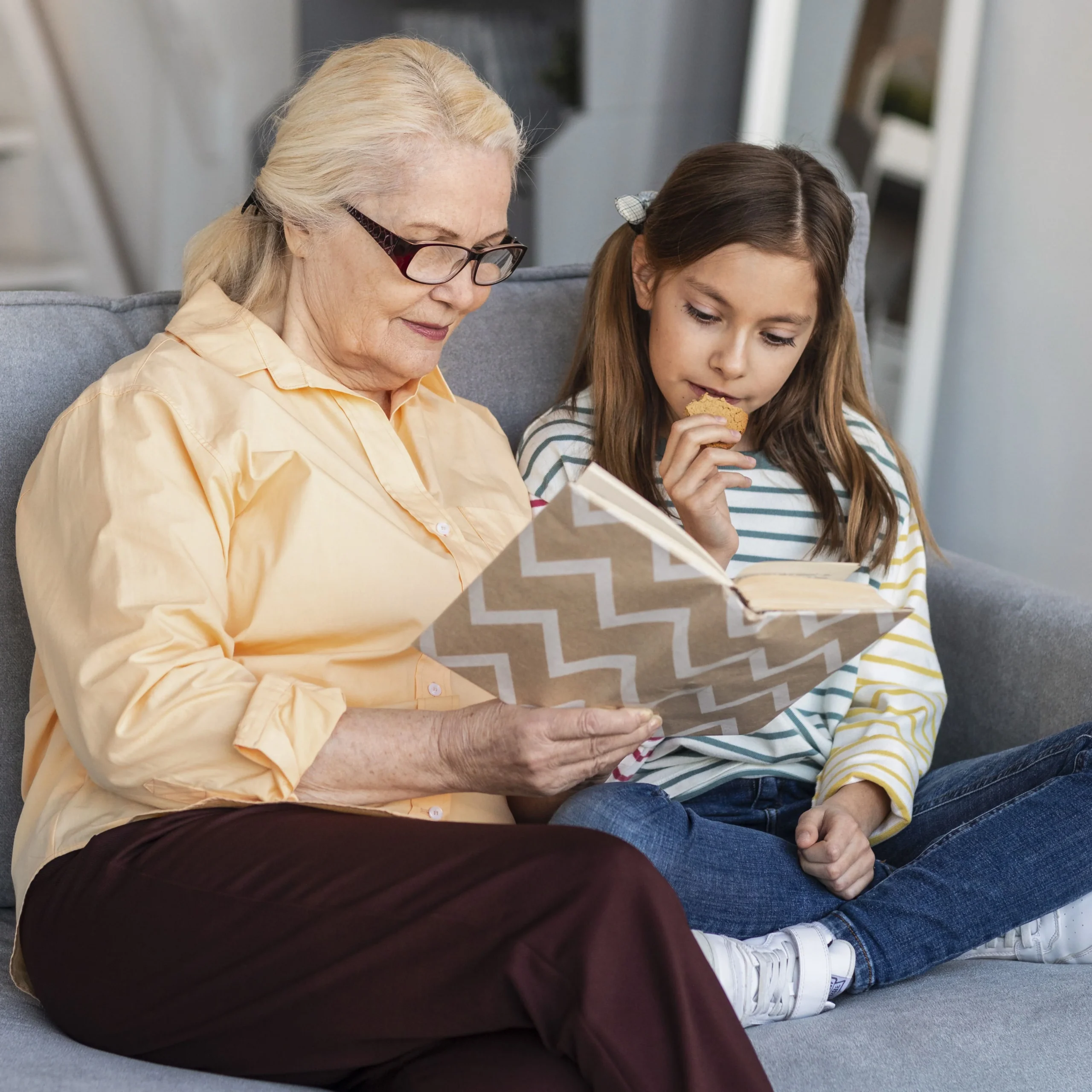 Grandmother reading with child while using hearing support